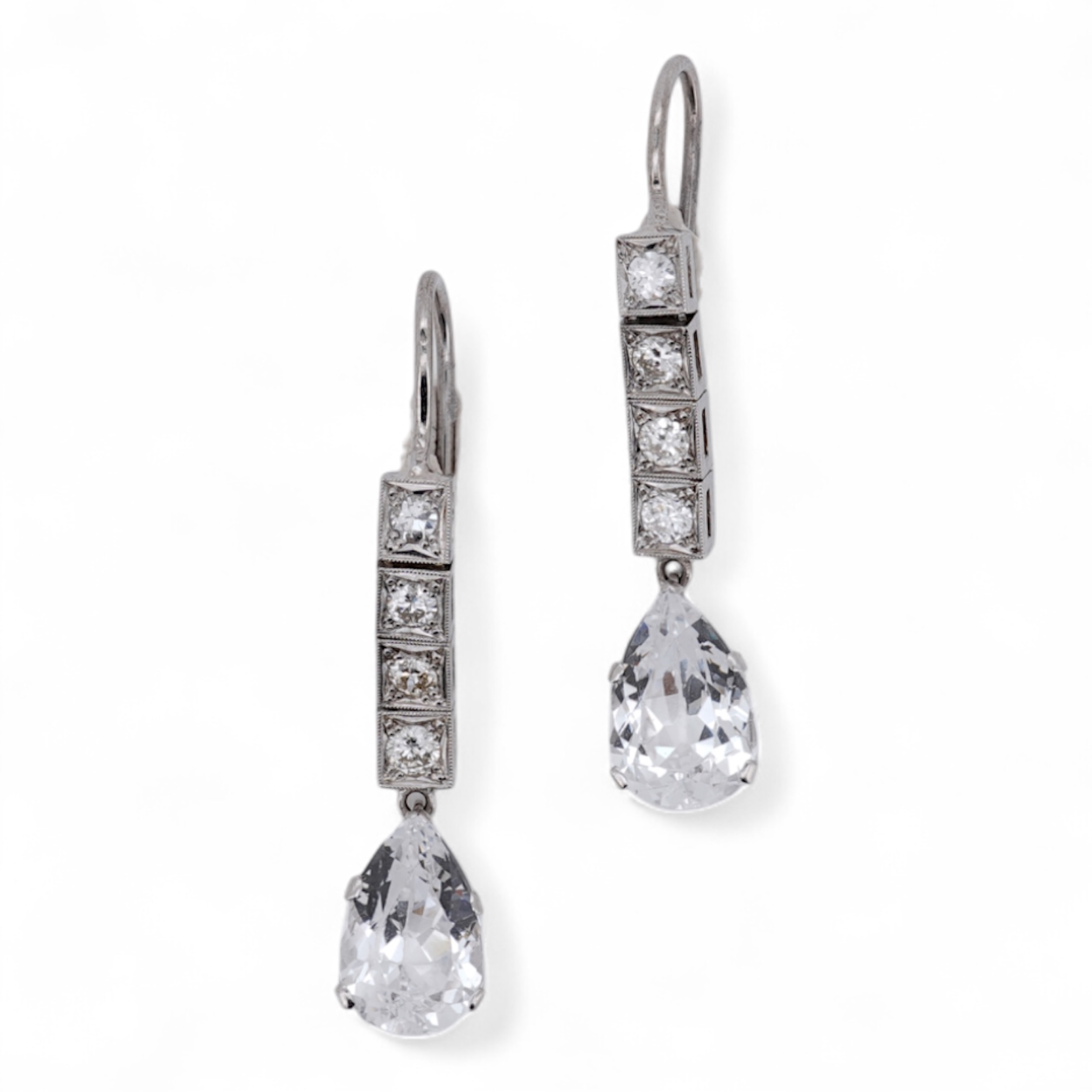A pair of white metal and four stone diamond set earrings, each with a cubic zirconia pear shaped drop, overall 42mm.